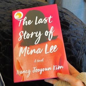 Hard cover book “The Last Story of Mina Lee” by Nancy Jooyoun Kim.